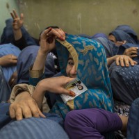 Afghan women wait to cast their ballots at a polling station in Mazar-i-sharif
