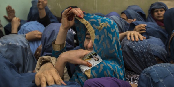 Afghan women wait to cast their ballots at a polling station in Mazar-i-sharif