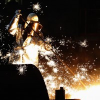 A worker of German steelmaker ThyssenKrupp controls a blast furnace in Duisburg