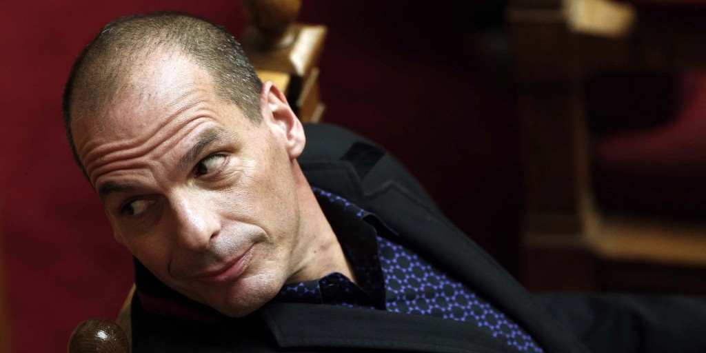 Greece's new leftist Finance Minister Yanis Varoufakis looks behind him while sitting after addressing the parliament in Athens
